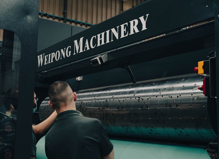 What is stereo printing: Two men working on stereo printing machine 